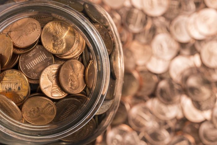 A child has a bottle full of pennies