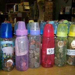 A child has a bottle full of pennies